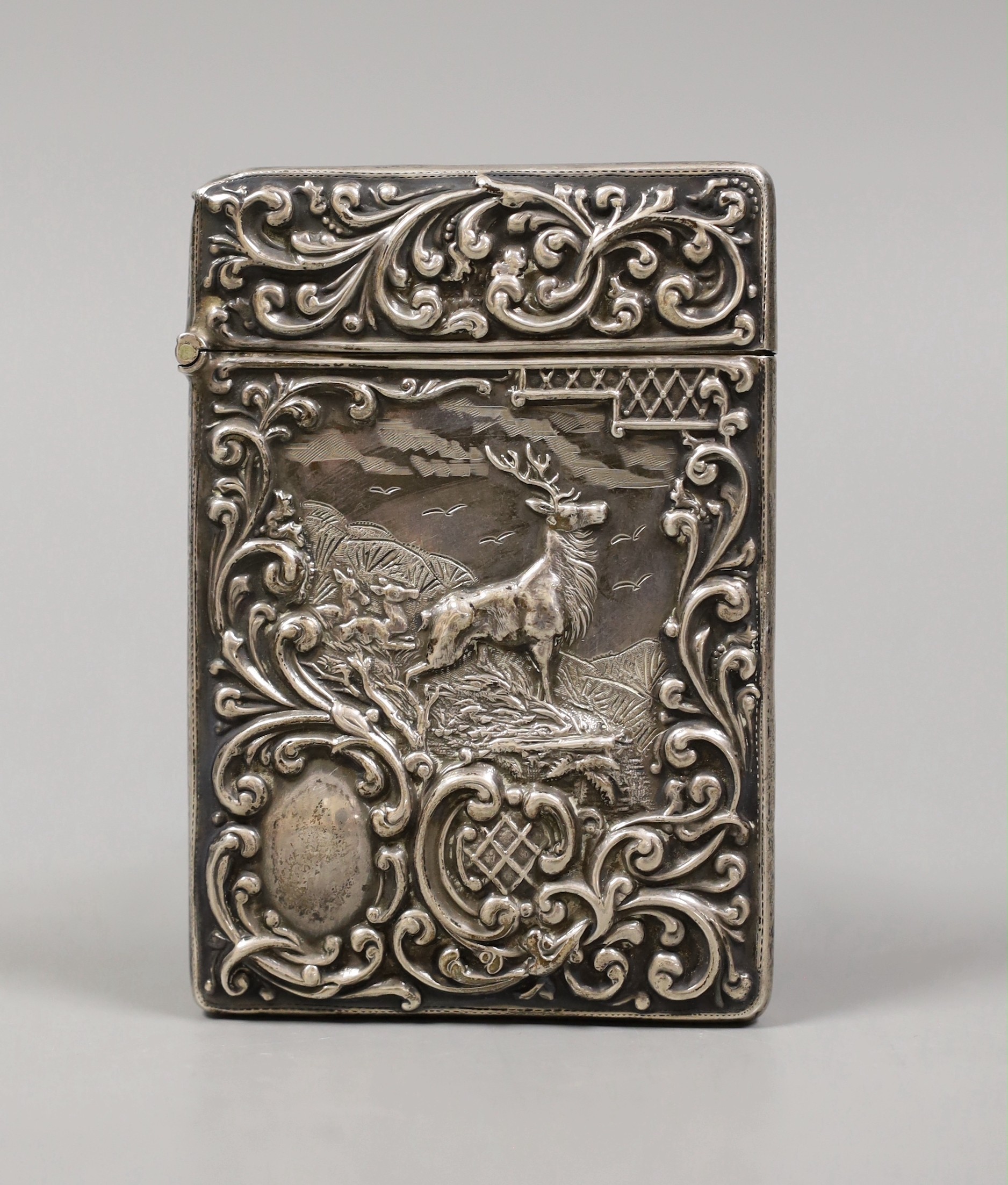 An Edwardian embossed silver card case, decorate d with stag in highland scene, Crisford & Norris, Birmingham 1903, 10.1cm.